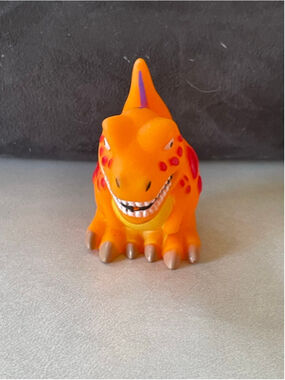 Amscan orange rubber T-Rex dinosaur water squirt toy